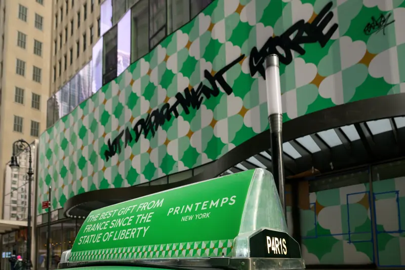 A green static taxi top matching a retailer's storefront