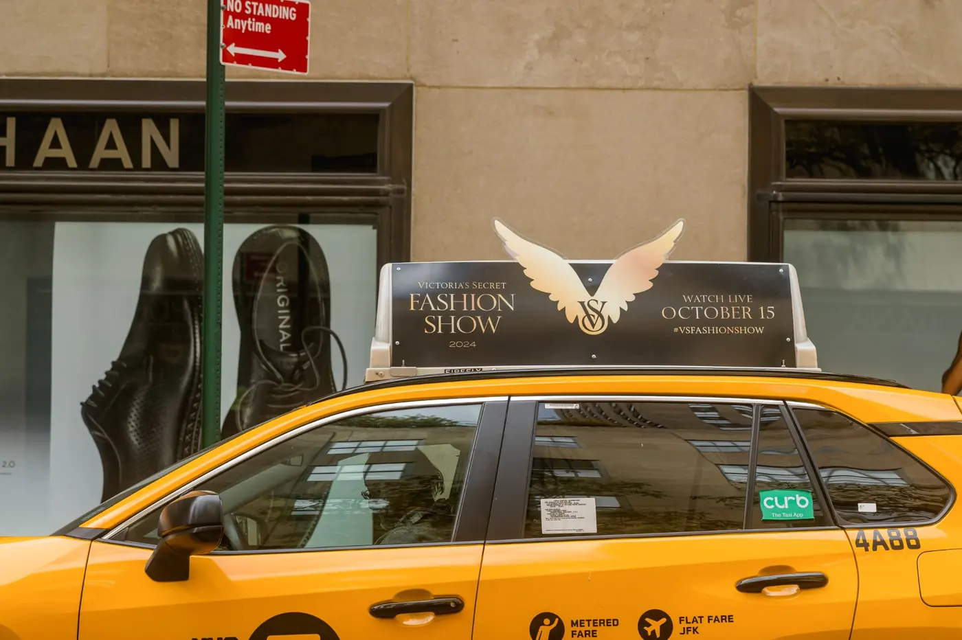 A Firefly Icon Extend top with die-cut wings breaking the frame above a yellow cab