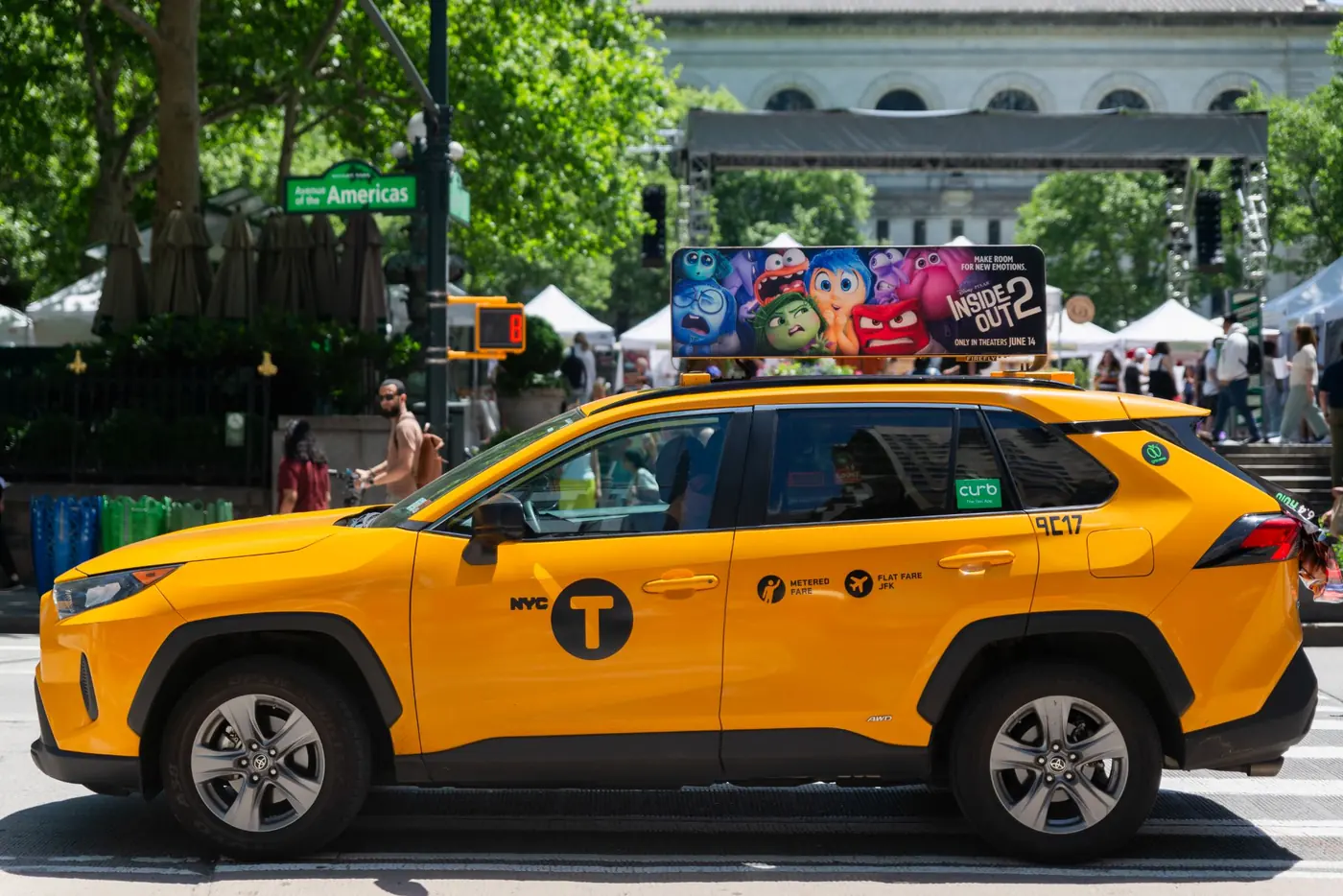 A yellow cab carrying a larger Firefly Icon XL top with edge-to-edge creative