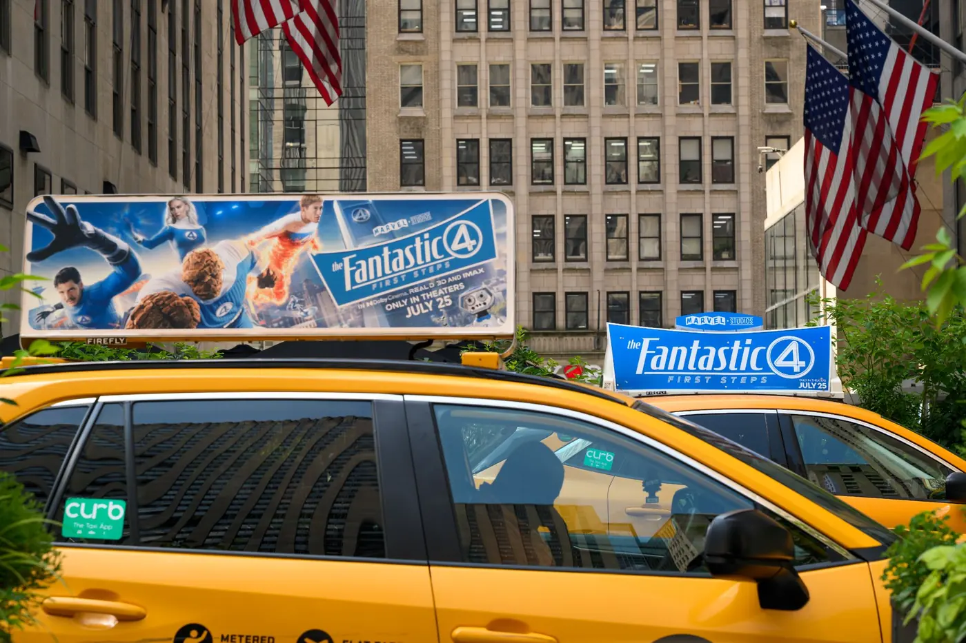 Two yellow cabs on Fifth Avenue with Icon Extend tops for a film launch